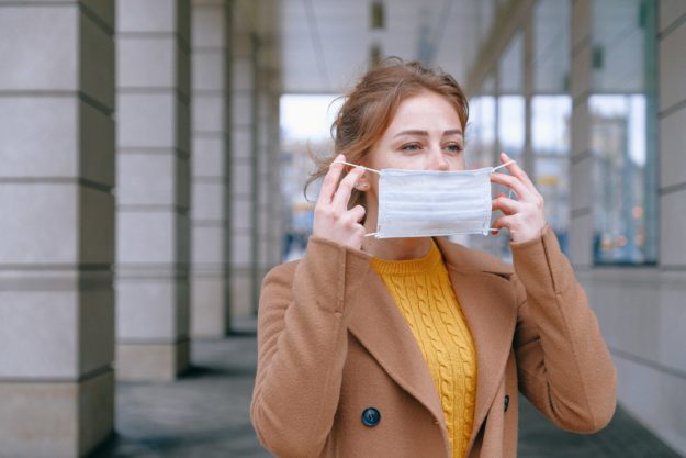 pexels-anna-shvets-3902732 woman putting on face mask