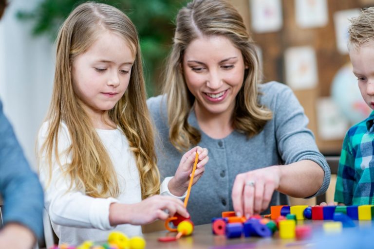 woman teaching children