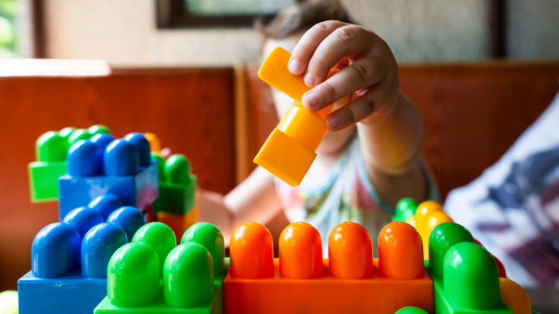 VOTE-7 child playing with building blocks