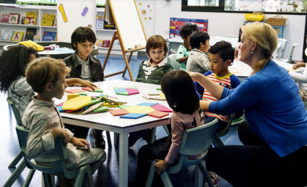 Group of diverse students at daycare children being taught