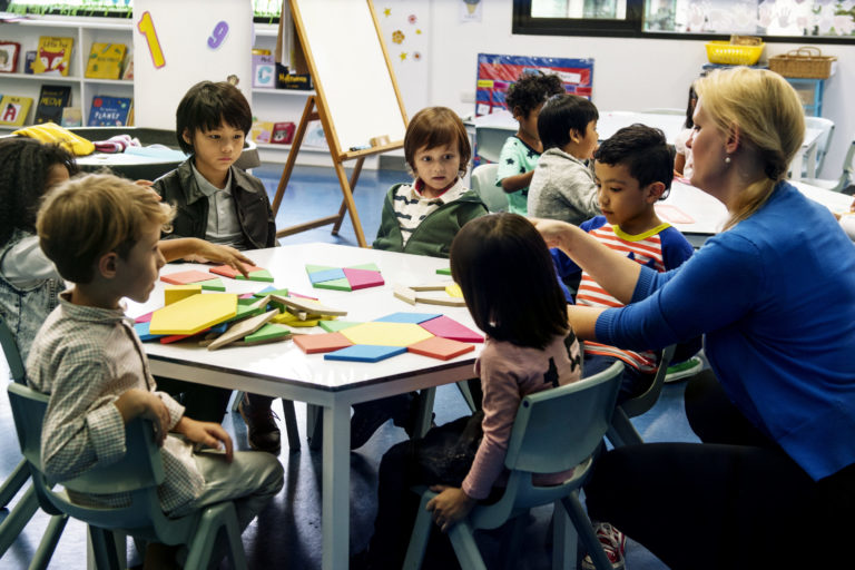 Group of diverse students at daycare children being taught